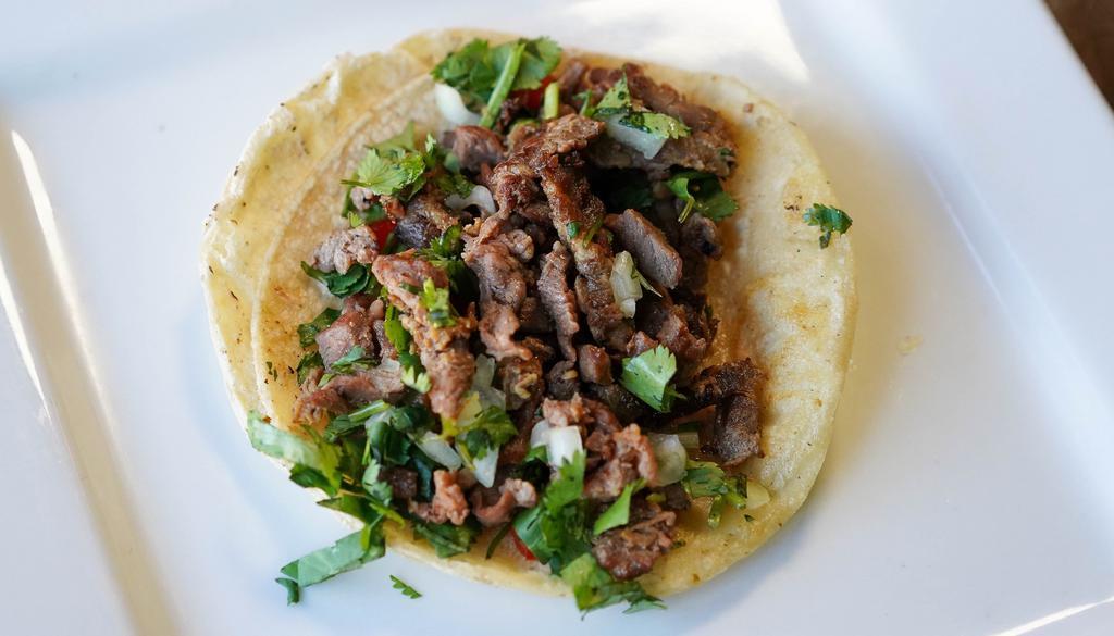 Mexican Taco · Corn tortilla, onions and cilantro and choice of meat.