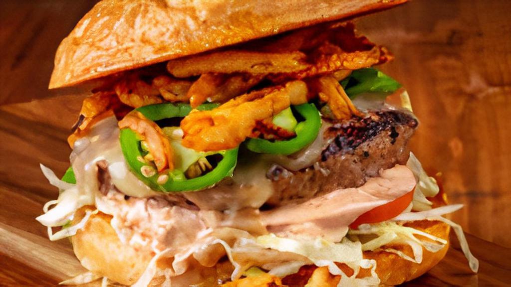 Jalapeno Burger · Topped with sauteed jalapenos, pepper jack cheese, and crispy onion tangles.
