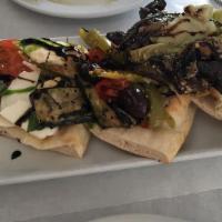 Bruschette Miste · Mozzarella eggplant bell peppers, olives, and artichokes. Glazed with honey balsamic dressing.