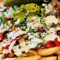 Mas Fries · Chili lime marinated steak, cilantro crema, guacamole, roasted red peppers, cotija cheese, s...