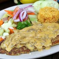 Filete De Pescado El Marinero · Fish fillet topped with our secret creamy mushroom sauce. Served with rice, steamed vegetabl...