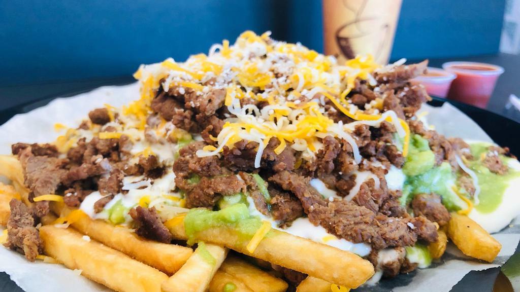 Carne Asada Fries · Fries cooked crispy, topped off with melted cheese, guacamole, sourcream & Carne Asada!