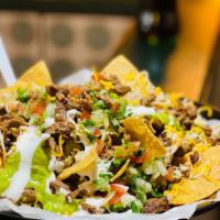 Super Nachos · Super Nachos are LOADED with crispy nachos, beans, melted cheese, sour cream, guacamole, pic...