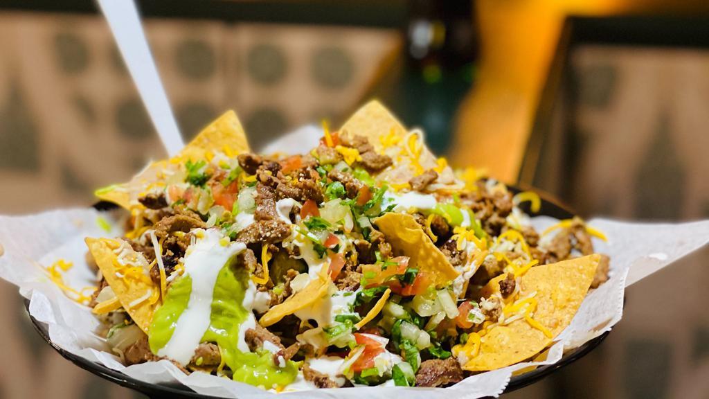 Super Nachos · Super Nachos are LOADED with crispy nachos, beans, melted cheese, sour cream, guacamole, pico de gallo, and Carne Asada!