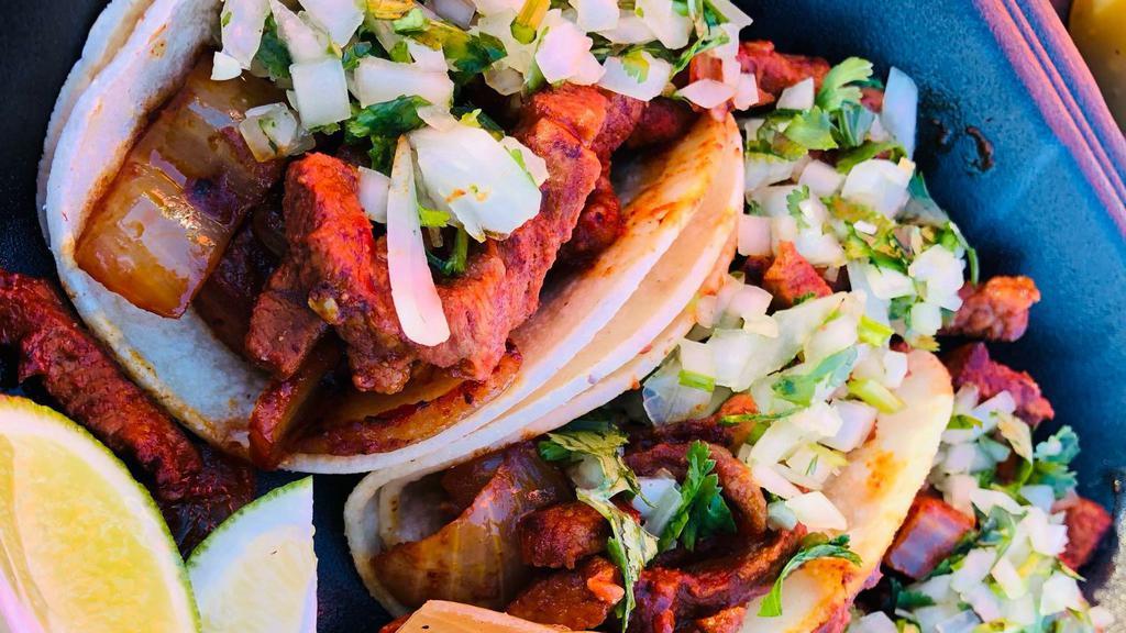 Street Tacos · Served with onion and cilantro.