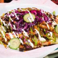Asada Fries · Sirloin Steak, red cabbage slaw, melted jack and cheddar, crema mexicana, spicy avocado sauc...
