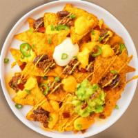 Vegan Nacho Overload · (Vegan) Salted tortilla chips topped with your choice of meat, guacamole, sour cream, salsa,...