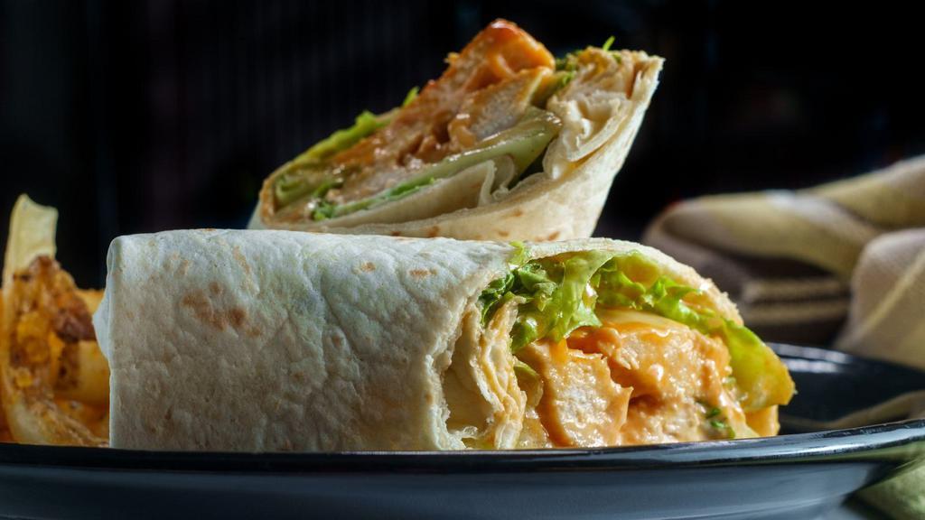 Buffalo Chicken Wrap · Wrap with grilled Buffalo chicken, crispy bacon, Swiss cheese, lettuce, tomato, blue cheese dressing.