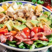 Cobb Salad · Tender grilled chicken, crispy bacon, grated cheddar cheese, green onions, chopped boiled eg...