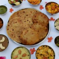 Paratha Of The Day · Stuffed bread with filling of potatoes, cauliflower or assorted vegetables. Served with yogu...