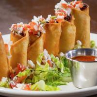 Tinga Taquitos · Chipotle spiced shredded chicken rolled in corn tortillas and fried. Served with guacamole a...