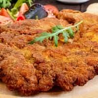 Milanesa De Pollo · Chicken breast, breaded and fried, served with refried beans and veggies