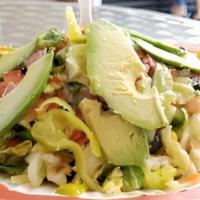 Italian Chopped Salad · Chopped greens with choice of salami or chicken breast, shredded cheese, garbanzo beans, bla...