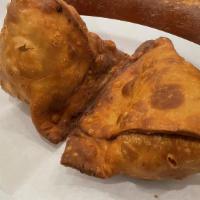 Lamb Samosa · Flaky pastry stuffed with mildly spiced mince lamb, potatoes, and peas.