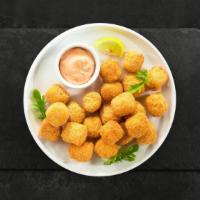 Totful · Shredded Idaho potatoes formed into tots, battered, and fried until golden brown. Served wit...