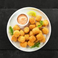 Cheesy Tots · Shredded Idaho potatoes stuffed with cheese formed into tots, battered, and fried until gold...