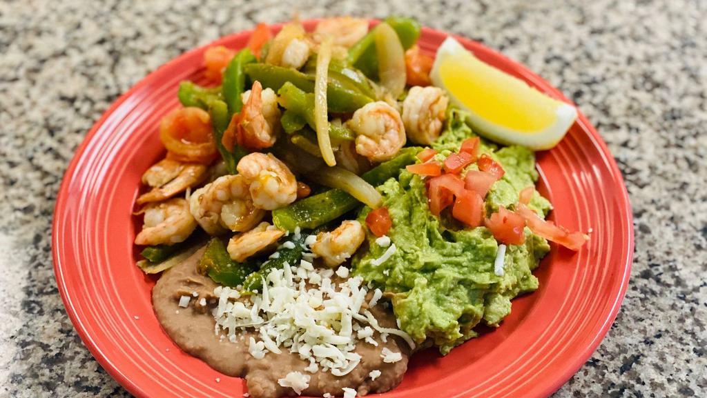 Shrimp Fajitas · Juicy grilled shrimp with a hint of garlic butter. Grilled with bell peppers, onions, and tomatoes. Served with rice, beans, guacamole, and tortillas.