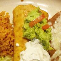 Chimichanga · Stuffed with choice of protein and cheese. Topped with guacamole and sour cream. Served with...