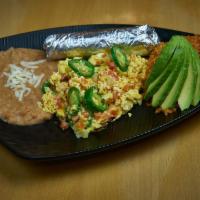 Huevos A La Mexicana · Two over easy or scrambled eggs mixed with tomato, white onion, avocado and a jalapeño peppe...