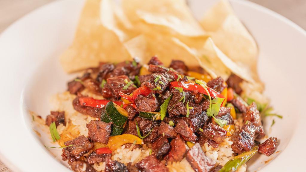 Asian Short Rib Rice Bowl · short rib, fajita veggies, rice served with pico de gallo and tortilla chips.