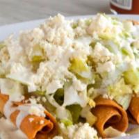 Taco Dorado (Taquitos) · 4 Rolled shredded chicken taquitos or folded potato with queso cotija taquitos topped with c...