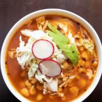 Pozole Rojo De Pollo · Shredded chicken breast with a red chili stew mild not spicy, hominy and three tostadas.