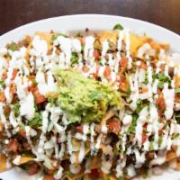 Nachos · Corn tortilla chips, topped with melted shredded Mexican cheese blend, choice of protein, pi...