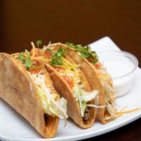 Hard Taco · Corn Tortilla Hard-shell Taco, Topped with lettuce, sour cream, cheese and tomato.