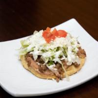 Sopes · A thick corn shell, with a layer of refried beans, choice of protein, lettece, sour cream an...