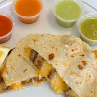 Mulitas · 2 Handmade corn tortillas and in between melted shredded cheese, choice of protein.