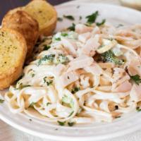 Fettuccine Alfredo · With mushrooms or broccoli. Topped with mozzarella cheese and served with garlic bread.