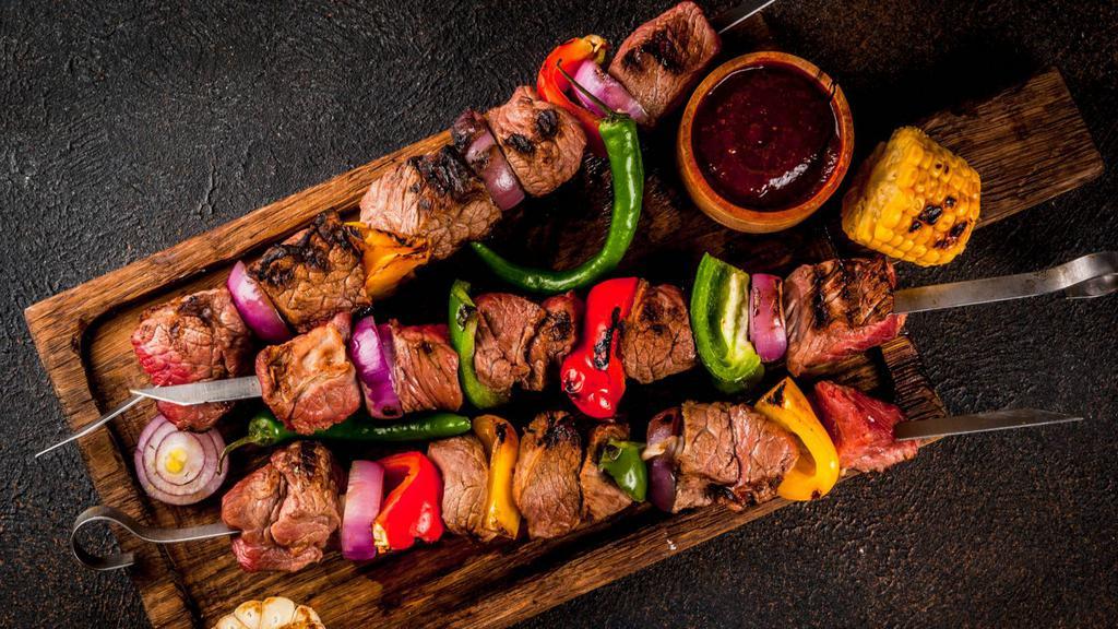 Beef Louleh Kabob · A skewer of fresh grilled seasoned ground beef over a bed of saffron rice and pita bread. Comes with your choice of yogurt, hummus or shirazi salad.