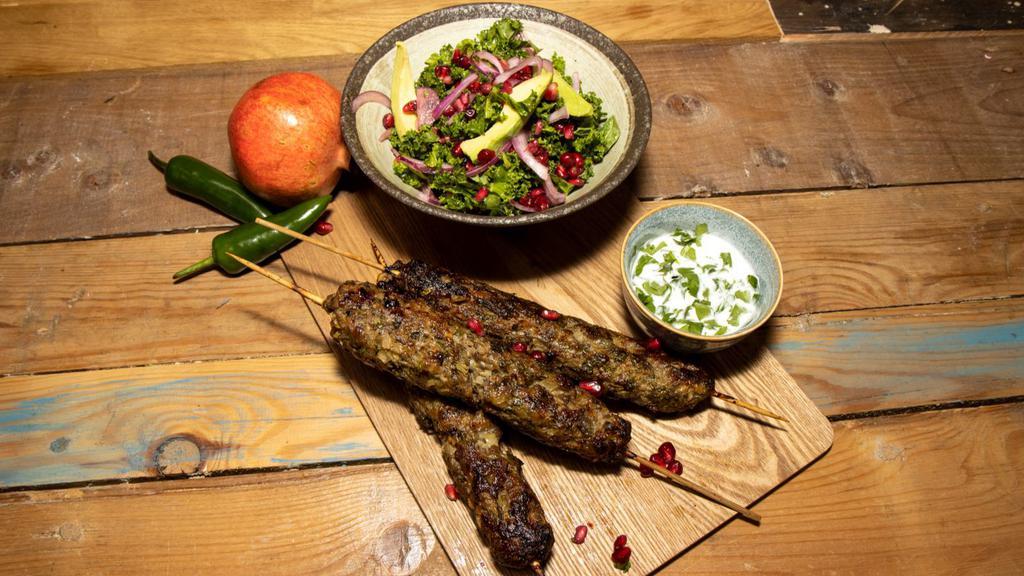 Lamb Kabob · A skewer of fresh grilled seasoned pieces of lamb over a bed of saffron rice and pita bread. Comes with your choice of yogurt, hummus or shirazi salad.