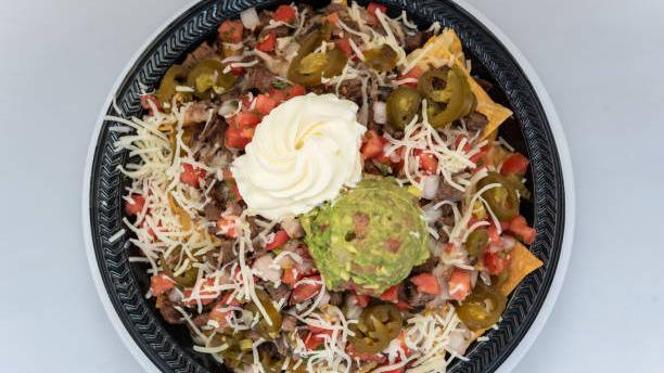 Carne Asada Nachos · Classic carne asada nachos with melted cheese, pico de gallo, beans, and your choice of toppings.