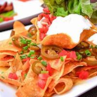 Carnitas Nachos · Classic carnitas nachos with melted cheese, pico de gallo, beans, and your choice of toppings.