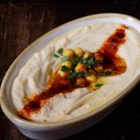 Hummus · Blend of garbanzo beans, tahini, fresh garlic, lemon, topped with olive oil.