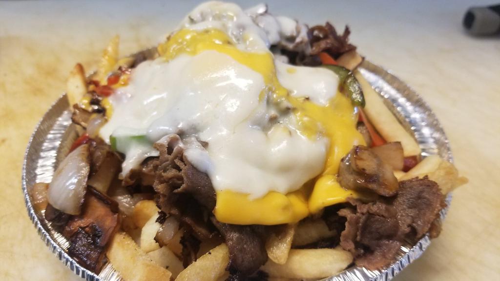 Philly Cheese · Philly steak, grilled peppers, mushrooms and onions provolone and American cheese a top a bed of fresh fries. A meal itself.