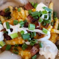 Basket Of Fries - Loaded · Crinkle cut fries fried to a golden brown and topped with cheddar jack cheese, bacon and sou...