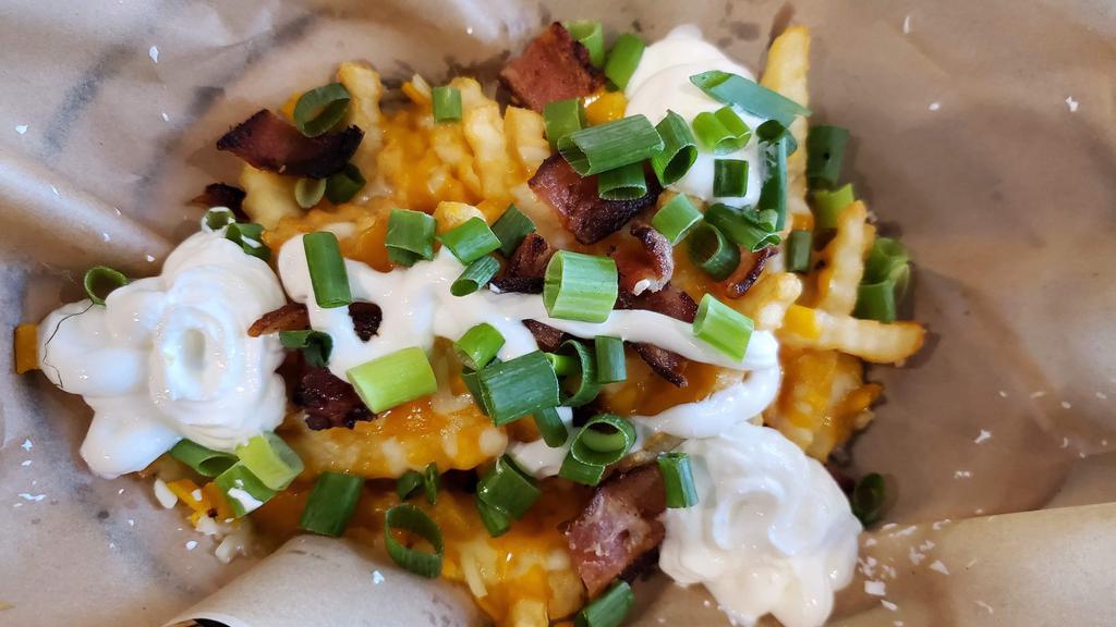 Loaded Fries · Crinkle-cut fries, aged cheddar jack cheese, sour cream,
chopped bacon & scallions (1130 CAL.)