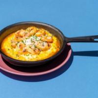 Shrimp + Grits · Creamy grits, Tabasco, honey butter, grilled shrimp, farm fresh egg, fresh chives