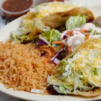 Works Hard Taco Platter · 2 grilled hard tacos on a flour shell with choice of meat, lettuce, cheese, sour cream and g...