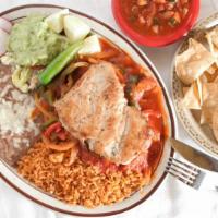 Pechugas Ranchera Platillo · 2  chicken breasts. Topped with ranchero sauce. Served with rice, beans, guacamole and torti...