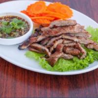 Grilled Marinated Pork · Grilled thai style marinated pork served with spicy lime fish sauce. Gluten free.