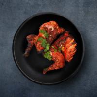 Tandoori Spring Chicken · Leg quarter tender pieces of chicken marinated with curd and spices and grilled in tandoor.