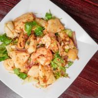 Spicy Seafood Salad · Mussels, shrimps, scallops, squids, fish, onions, scallions mixed with spicy lime dressing. ...