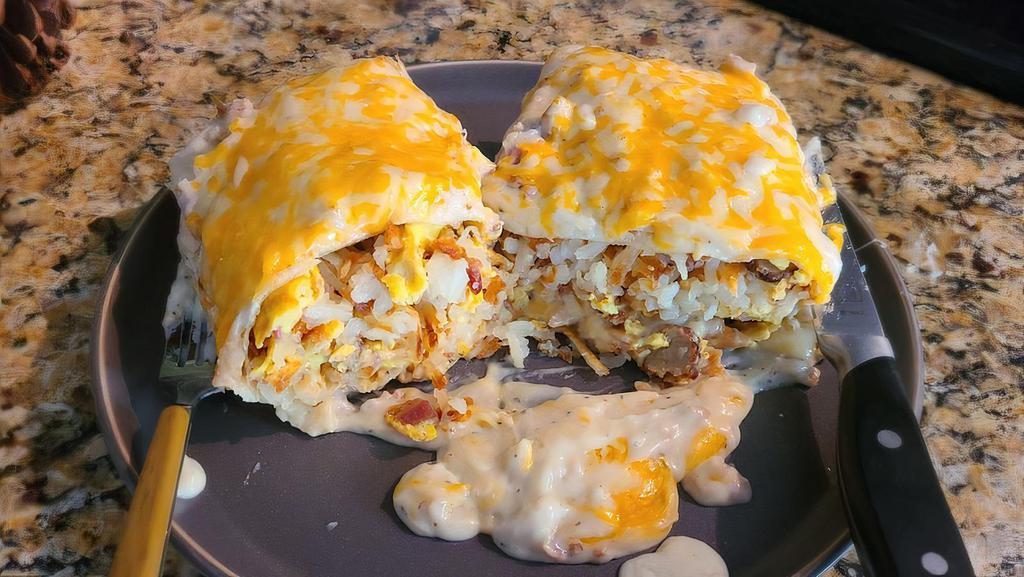 Breakfast Burrito · 3 eggs, ham, bacon, sausage, hash browns & cheddar cheese.