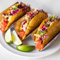 Noke Tacos (3) · Spicy sesame ahi tuna (raw), garlic chili cabbage slaw, lime, crispy corn tortilla