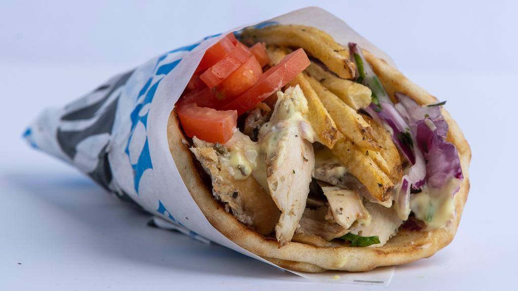 Chicken Gyro Pita · Thin slices of seasoned boneless chicken, stacked and cooked on a vertical rotisserie, served on a warm pita bread filled with fries, tomatoes, onions, lettuce and mustard sauce.