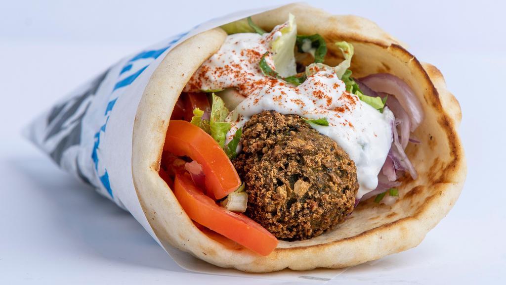Falafel Pita · Freshly made falafel served on warm pita bread filled with lettuce, tomatoes, onions and tzatziki sauce.