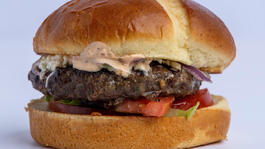Grecian Beefteki Burger · 1/3 pound beef and lamb patty seasoned to perfection (or falafel) with feta cheese served on a bun with lettuce, tomato, onions and feta sauce.